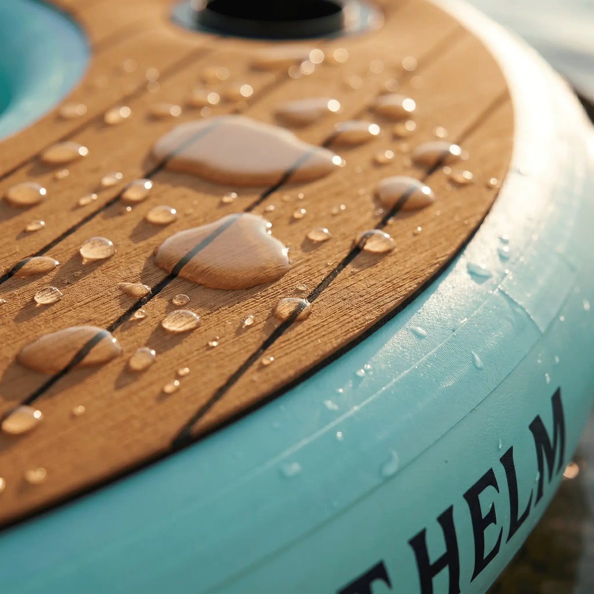 Close-up of the floating bar tabletop and teal inflatable material with water droplets