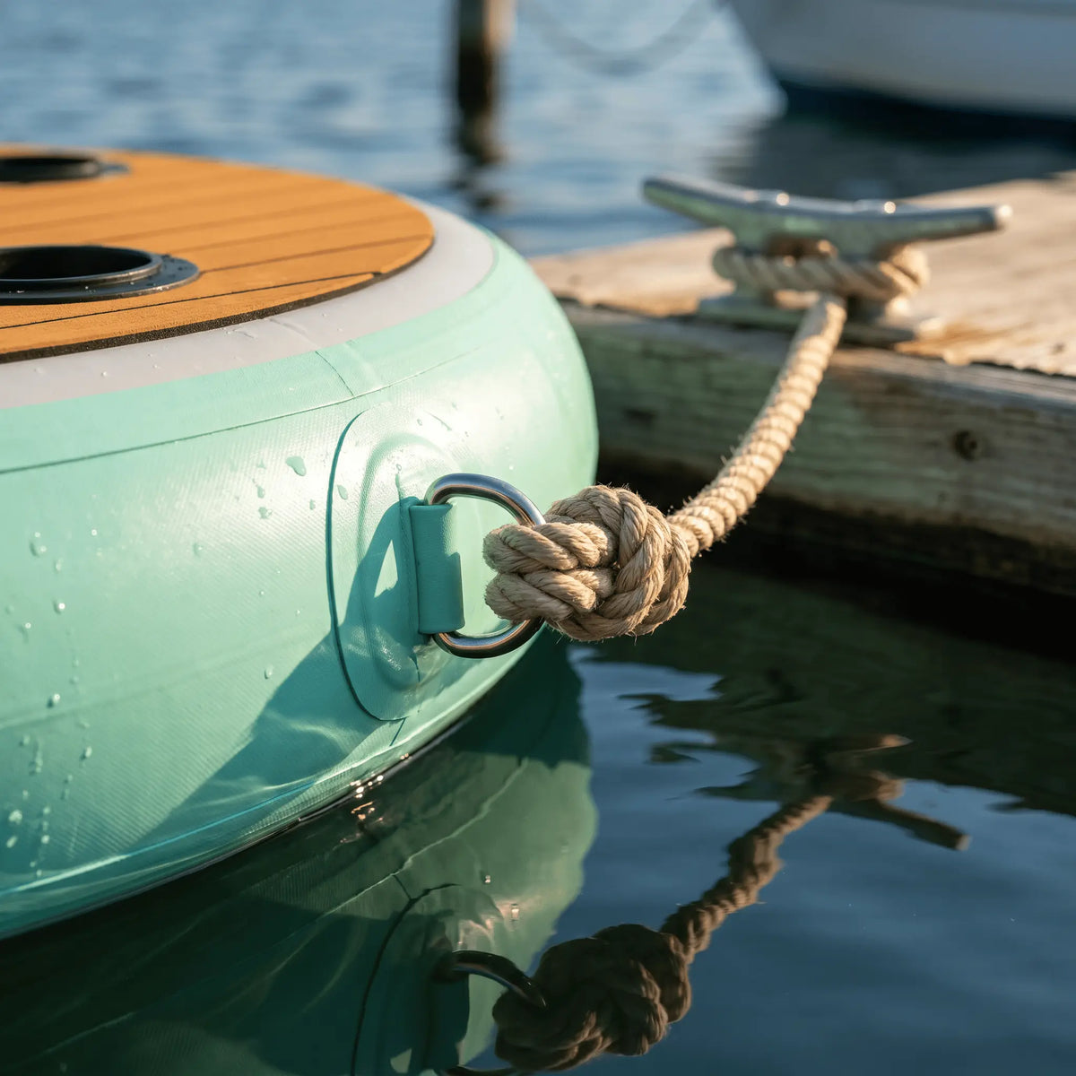 Close-up of the floating bar secured to a dock with a tether rope